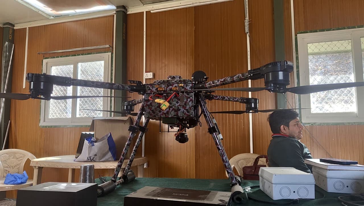Heavy-lift survey drone and sensing equipment prepared indoors for field deployment